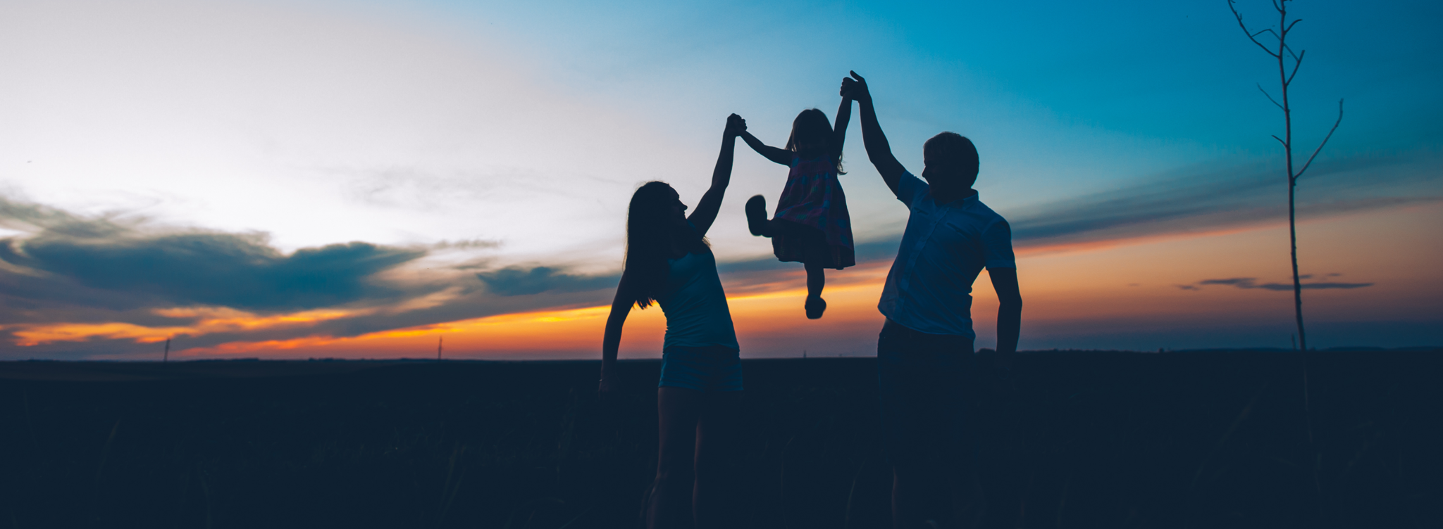 Adoption Centre of British Columbia - Adoptive parents at sunset with adopted daughter